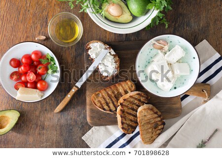 Foto stock: Red Knife Cutting Feta Cheese