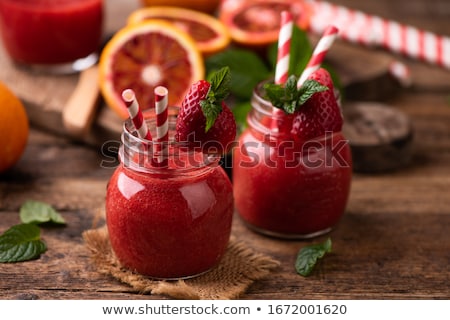 Foto stock: Strawberry Smoothie In Glass Jar Over Wood Table