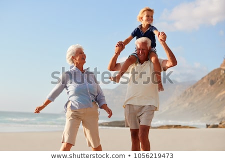 Сток-фото: Grandparents Playing With Grandchildren On Beach