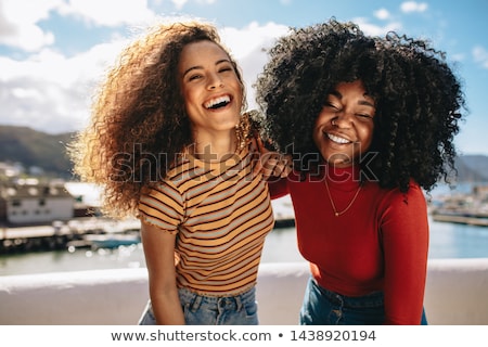 Zdjęcia stock: Cheerful Young Woman With Curly Hair Standing