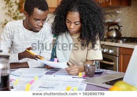 Foto stock: Young Man Frustrated At His House And Tax Bills