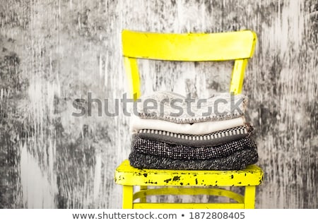 Stockfoto: Pile Of Knitted Warm Grey And White Blankets Scarves And Woolen