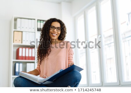 Foto stock: Businesswoman Meditating On The Floor And Smiling At The Camera