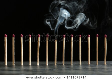Stok fotoğraf: Consumed Match Against A Black Background