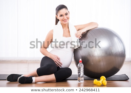 Foto stock: Pregnant Woman Exercising Isolated On White