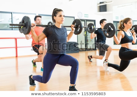 Foto d'archivio: Young Bodybuilder Doing Weightlifting