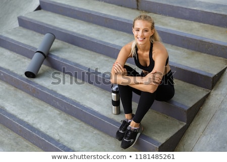 Сток-фото: Amazing Young Sports Woman Sitting On Steps Outdoors