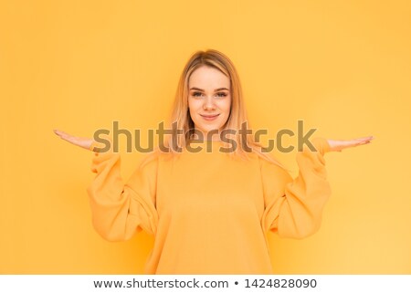 Foto stock: Cute Smiling Young Girl Shrugging Her Shoulders