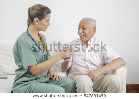 Stok fotoğraf: Nurse Giving Senior Man Prescription Drugs