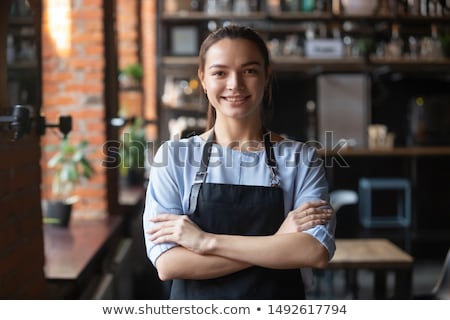 Stockfoto: Portrait Of Smiling Waiter Standing With Arms Crossed