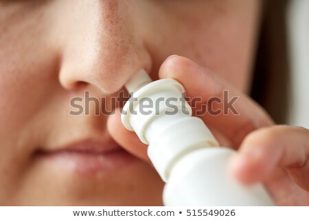 Imagine de stoc: Close Up Of Sick Woman Using Nasal Spray