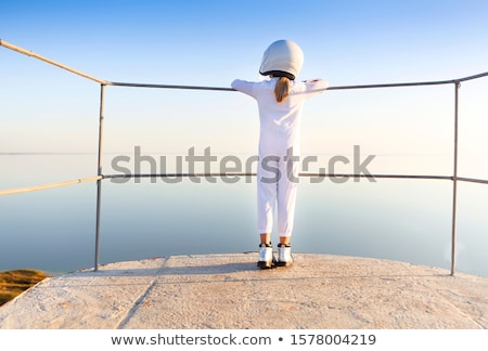 Foto d'archivio: Astronaut Futuristic Kid Girl With White Full Length Uniform And