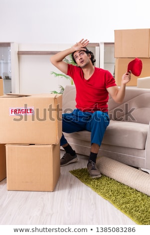 Stock foto: Young Male Contractor With Boxes Working Indoors