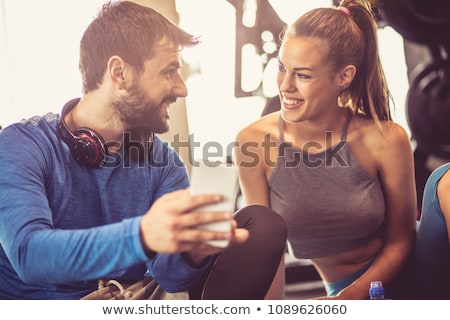 ストックフォト: Couple Using Gym Equipment