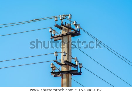 Stock fotó: High Voltage Lines Against A Blue Sky