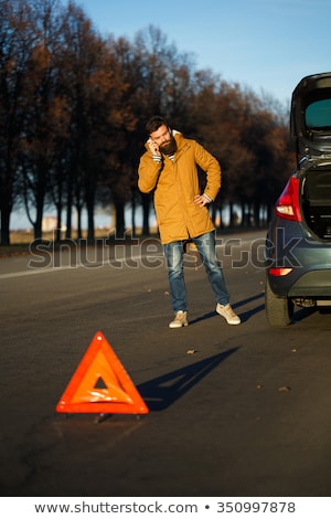 Foto d'archivio: Man Examining Damaged Automobile Cars After Breaking