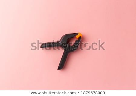 Foto stock: Plastic Black Orange Clamps On White