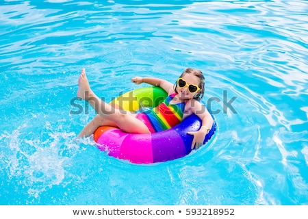 ストックフォト: The Little Baby Girl Playing With Toys In Inflatable Pool In The Summer Sunny Day