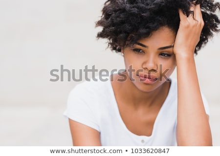 Stockfoto: Portrait Of A Worried Woman With Dark Curly Hair