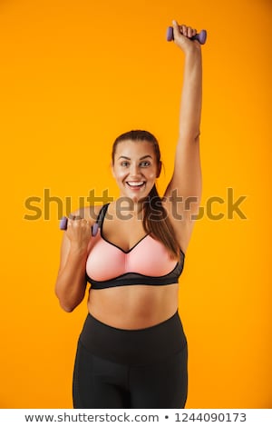 Foto d'archivio: Portrait Of Beautiful Big Sportswoman In Sportive Bra Lifting Du