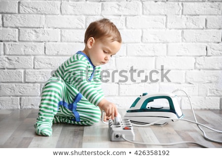 ストックフォト: Toddler Playing With Electric Iron