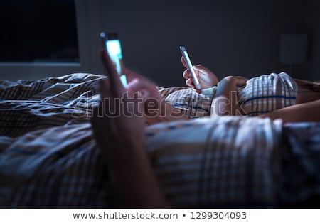 Сток-фото: Couple With Smartphones In Bed