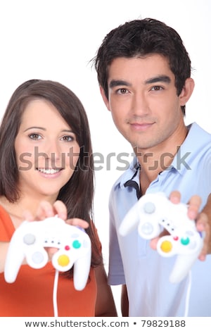 Foto stock: Couple Stood Holding Video Game Control Pads