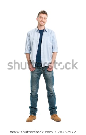 Foto stock: Young Fashion Man Stands With Hands In Pockets