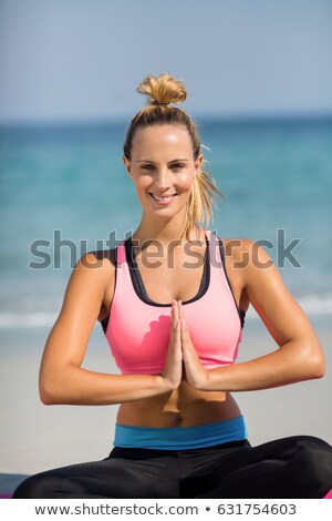 Foto stock: Close Up Of Woman Meditating While Sitting On Shore