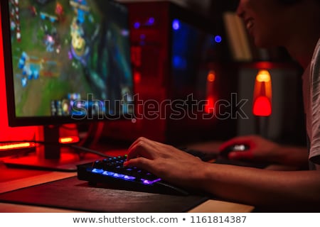 Foto stock: Photo Of Teenage Gamer Boy Playing Video Games On Computer In Da