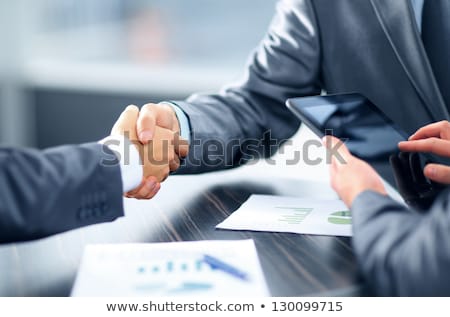 Stok fotoğraf: Handshaking Business Person In Office Concept Of Teamwork And Partnership Double Exposure