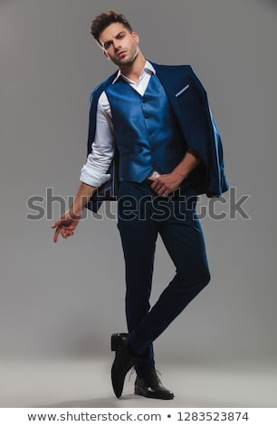 Stockfoto: Gentleman Wearing Blue Suit On Shoulders Standing With Legs Cros