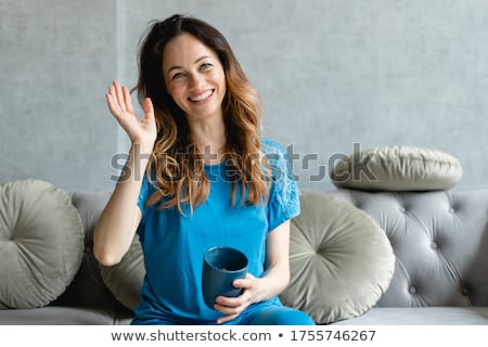 Zdjęcia stock: Smiling Attractive Woman Drinking A Coffee Sitting On Her Bed
