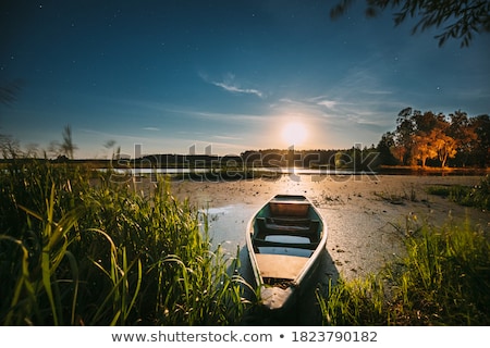 Stock fotó: Illuminated Rowboats At A Lake At Night