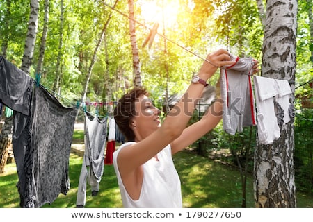 [[stock_photo]]: Woman Hanging Clothes