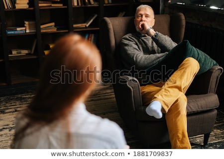 Stock photo: Businessman Listen To Young Attractive Man Explaining About His