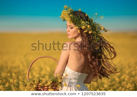 ストックフォト: Brunette Woman In A Yellow Flowers Field