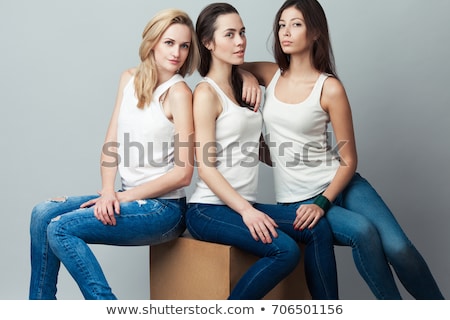 Young Blonde Woman Wearing Jeans Sitting On Cube Сток-фото © Augustino