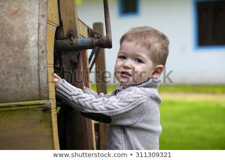 Zdjęcia stock: 2 Years Old Curious Baby Boy Managing With Old Agricultural Mach