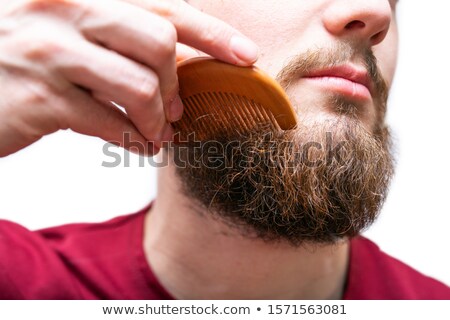 [[stock_photo]]: Young Man Comb His Beard And Moustache