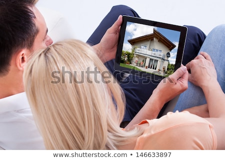 Stockfoto: Couple Looking At Notebook