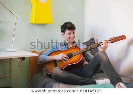 Foto d'archivio: Teenage Boy Playing His Guitar