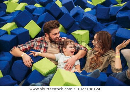 Foto stock: Young Woman Playing With Soft Blocks At Indoor Children Playground In The Foam Rubber Pit In The Tra