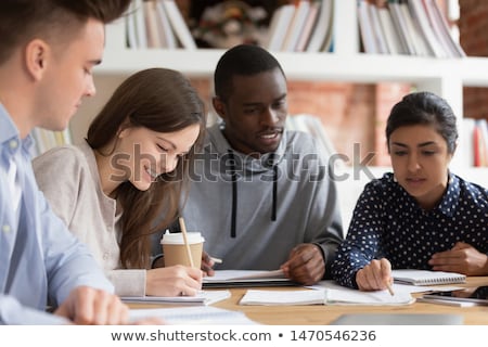 Stock foto: Concentrated Young Multiethnic Friends Girls Doing Homework Outdoors In Park