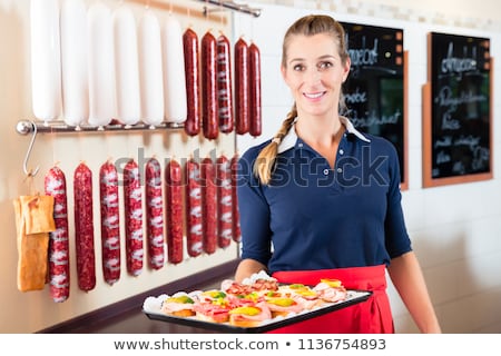 ストックフォト: Sales Woman In Butcher Shop Offering Finger Food