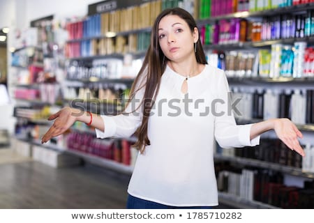 [[stock_photo]]: Beautiful Young Woman Standing Near Supermarket Showcase