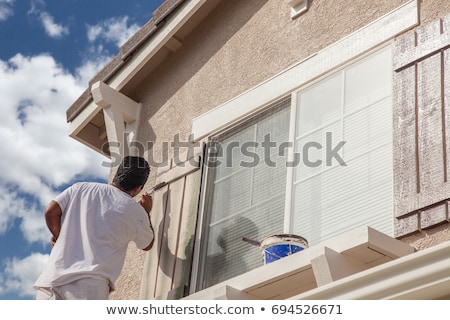 Stock fotó: House Painter Painting The Trim And Shutters Of Home