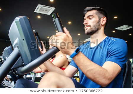 [[stock_photo]]: Fit Group Of People Using Exercise Bike Together