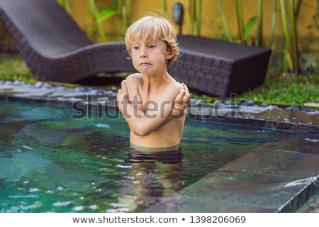 Stock photo: Young Boy Was Frozen In The Pool Very Cold Water In The Pool Need Heated Water Banner Long Format