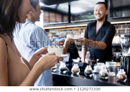 Young Woman Holding A White Cup Of Coffee Next To Her Partner Foto stock © Kzenon